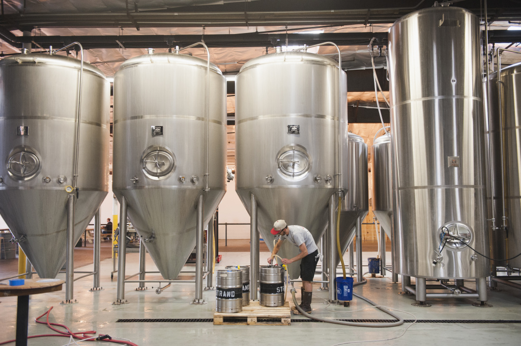 Torrance breweries Brad Couey cleans kegs at Strand Brewery in Torrance on May 30, 2018. Strand provided the momentum that pushed Torrance to become the brewery mecca it is today.