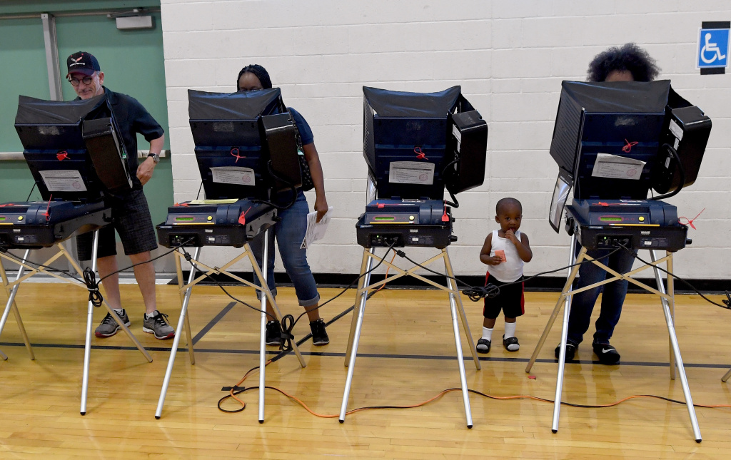 Nation Goes To The Polls In Contentious Presidential Election Between Hillary Clinton And Donald Trump Voters cast their ballots at voting machines at Shadow Ridge High School on Election Day on November 8, 2016 in Las Vegas, Nevada.