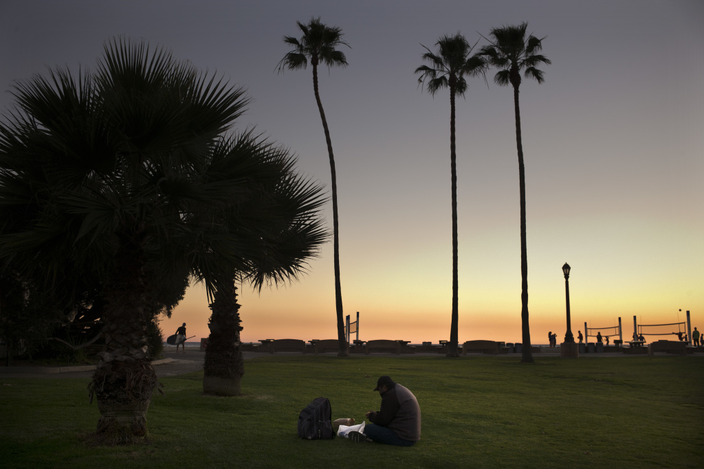 Homeless Crisis Saviors or Enablers Sitting on the lawn at Doheny State Beach, Gholamreza Hagihgih, a 59-year-old Iranian immigrant who has been homeless for 20 years, eats his meal provided by a nonprofit organization Thursday, Dec. 21, 2017, in Dana Point, Calif. Goodhearted neighbors heartbroken over the rising number of homeless in their communities are dishing out hot meals, providing mobile showers and handing out sandwiches to those in need, hoping they can make a difference.