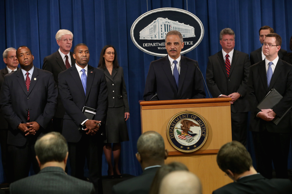 Standard & Poor's Ratings Services upgraded its outlook Monday for the U.S. government's long-term debt. (File photo: U.S. Attorney General Eric Holder at a news conference in February 2013 in which a civil lawsuit against the ratings agency Standard & Poor's was announced over its pre-fiscal crisis bond ratings).
