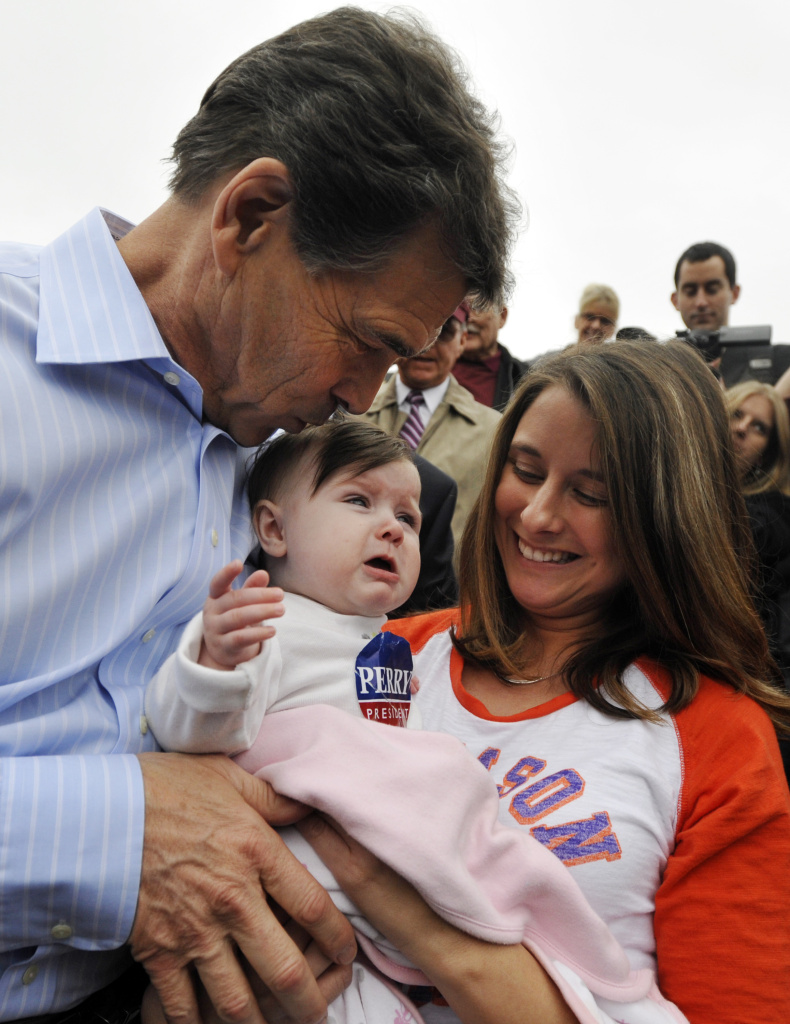 GOP Presidential Candidate Rick Perry Returns To Campaign Trail In South Carolina SPARTANBURG, SC- JANUARY 8: Republican presidential candidate, Texas Gov. Rick Perry (L) kisses 7-month-old Elaina Stephens, as her aunt Candi Tennyson (R) looks on during a campaign stop at the Beacon Drive-In January 8, 2012 in Spartanburg, South Carolina. After suffering a fifth place finish in the Iowa caucuses, Gov. Perry has returned to the campaign trail in South Carolina with events for the next several days in hopes of keeping his candidacy alive.