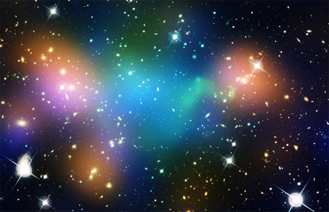This composite image shows the distribution of dark matter, galaxies, and hot gas in the core of the merging galaxy cluster Abell 520, formed from a violent collision of massive galaxy clusters.
The natural-color image of the galaxies was taken with NASA's Hubble Space Telescope and with the Canada-France-Hawaii Telescope in Hawaii.
Superimposed on the image are "false-colored" maps showing the concentration of starlight, hot gas, and dark matter in the cluster. Starlight from galaxies, derived from observations by the Canada-France-Hawaii Telescope, is colored orange. The green-tinted regions show hot gas, as detected by NASA's Chandra X-ray Observatory. The gas is evidence that a collision took place. The blue-colored areas pinpoint the location of most of the mass in the cluster, which is dominated by dark matter. Dark matter is an invisible substance that makes up most of the universe's mass. The dark-matter map was derived from the Hubble Wide Field Planetary Camera 2 observations by detecting how light from distant objects is distorted by the cluster of galaxies, an effect called gravitational lensing.
The blend of blue and green in the center of the image reveals that a clump of dark matter resides near most of the hot gas, where very few galaxies are found. This finding confirms previous observations of a dark-matter core in the cluster. The result could present a challenge to basic theories of dark matter, which predict that galaxies should be anchored to dark matter, even during the shock of a collision.
Abell 520 resides 2.4 billion light-years away.