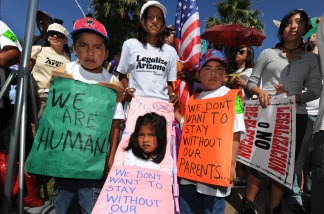 Members of the Aguila family join others to demonstrate against Arizona's tough new immigration laws at a large rally in Phoenix on May 29, 2010.