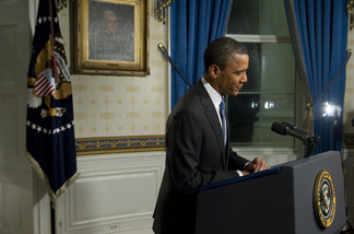 President Barack Obama leaves after speaking during a reenactment of his speech on the budget for press photographers in the Blue Room of the White House in Washington, DC, April 8, 2011, after Congress reached an agreement to pass a budget.