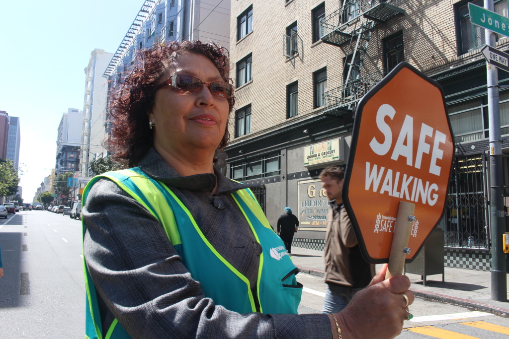 Safe Passage Margarita Mena, 60, stops traffic for pedestrians in San Francisco’s Tenderloin neighborhood on April 24, 2018. Mena, a Tenderloin resident, helped start the Safe Passage program.