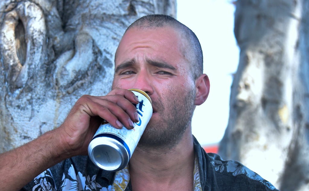 US-HOMELESSNESS-CALIFORNIA-VETERANS Homeless veteran Joseph Shokrian has a beer while reflecting on past experiences in his life with journalists on a streetcorner near Skid Row in downtown Los Angeles, California on June 20, 2017.