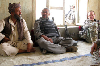 U.S. Army 1st Lt. Mike Kehoe (right) sits down for a chat with a village elder and the local police chief in Ali Abad, Kunduz.