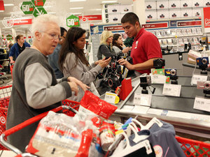 Target shoppers look for Black Friday deals in Los Angeles. U.S. consumers increased their spending at retail businesses in December 2012, buying more autos, furniture and clothing. File photo.