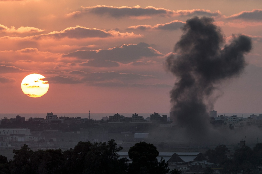 PALESTINIAN-ISRAEL-CONFLICT-GAZA A picture taken from the Israeli Gaza border shows smoke billowing from the Gaza Strip following an Israeli air strike on July 16, 2014.