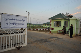 Myanmar policemen stand guard outside a compound of official guest houses where Members of Parliament stay for the duration of the opening sesion of the national parliament in the capital Naypyidaw on January 31, 2010.