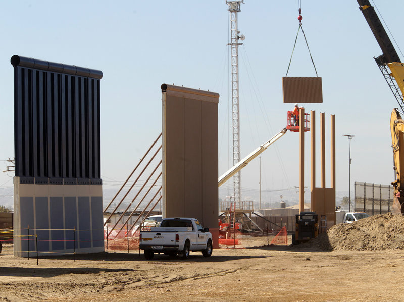 Crews work at the construction site of prototypes for President Trump's border wall in San Diego County. Crews work at the construction site of prototypes for President Trump's border wall in San Diego County.