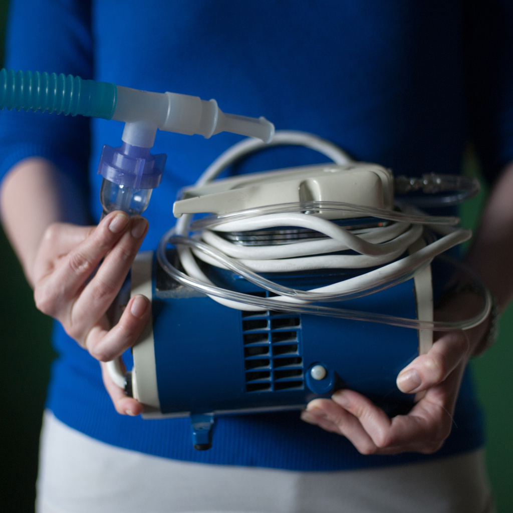 Virginia Rady, 28, holds her old nebulizer at her home in Dallas. Rady was diagnosed with chronic persistent asthma at age 2. She underwent a series of three outpatient surgeries between December 2012 and February 2013 for a procedure known as bronchial thermoplasty. She says the procedure has changed her life, allowing her to remove her nebulizer from her bedside.