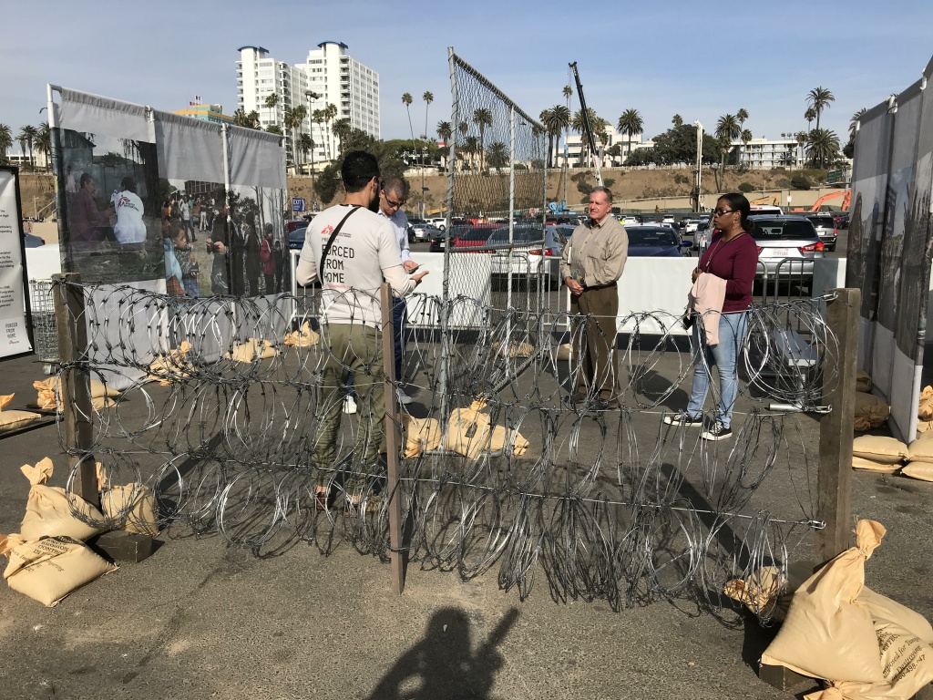 The barbed wire barricades are meant to represent what refugees have to deal with as they flee their home countries. The barbed wire barricades are meant to represent what refugees have to deal with as they flee their home countries.