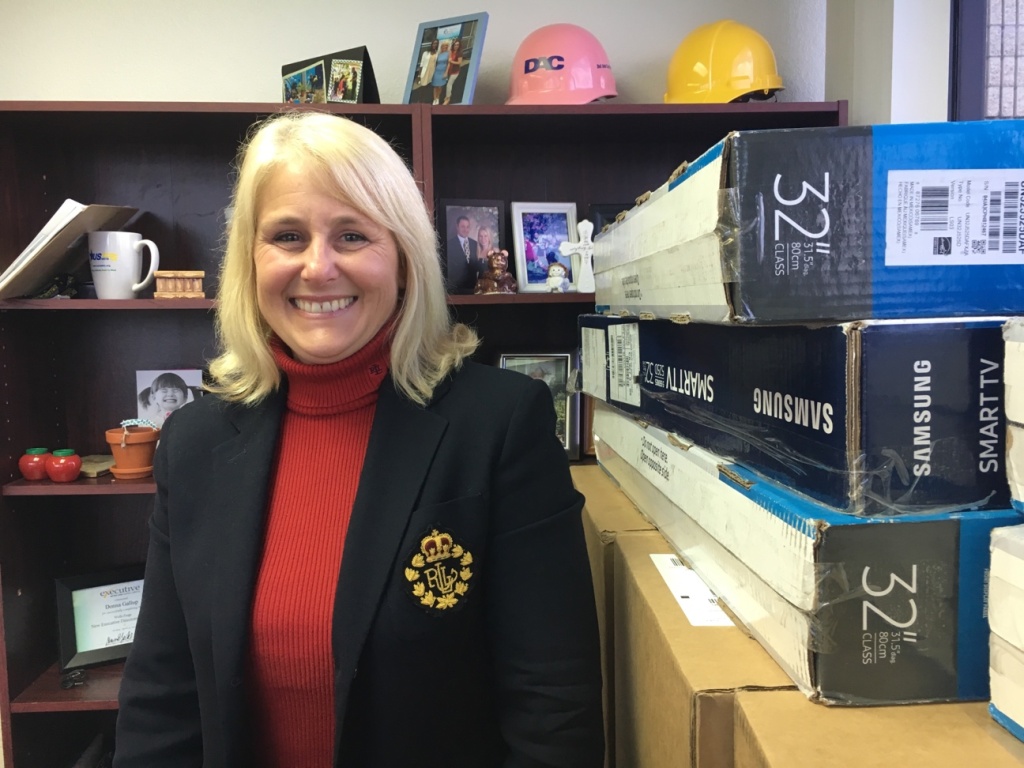 Potter's Lane Donna Gallup, president and CEO of American Family Housing, in her office next to boxes of donated televisions that will go into the apartments at Potter’s Lane. The non-profit is overseeing the housing project in Midway City located next to its offices, where counselors will maintain regular contact with the veterans who move in next door.