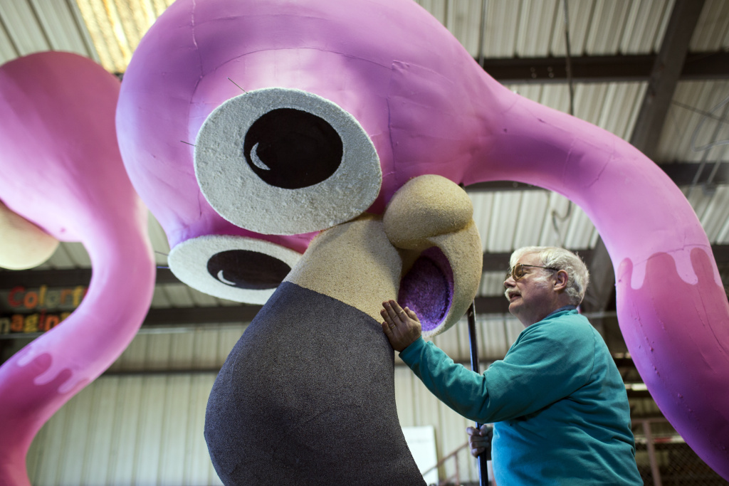 Rose Parade Float Decoration - 1 Volunteer David Gaydosh of Hawthorne patches poppyseed onto a bird beak at Sierra Madre Rose Float Association's barn on Tuesday morning, Dec. 29, 2015. The birds are part of a float for the 2016 Rose Parade on New Year's Day.