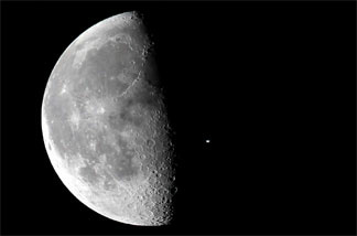 The International Space Station flew across the face of the moon over NASA's Kennedy Space Center in Florida approximately 15 minutes before the launch of space shuttle Discovery on the STS-131 mission.