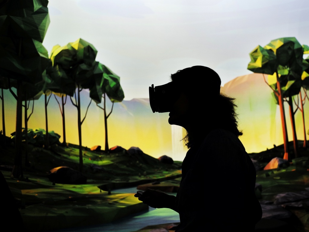 A woman tries on Google's virtual reality device A woman tries on Google's virtual reality device