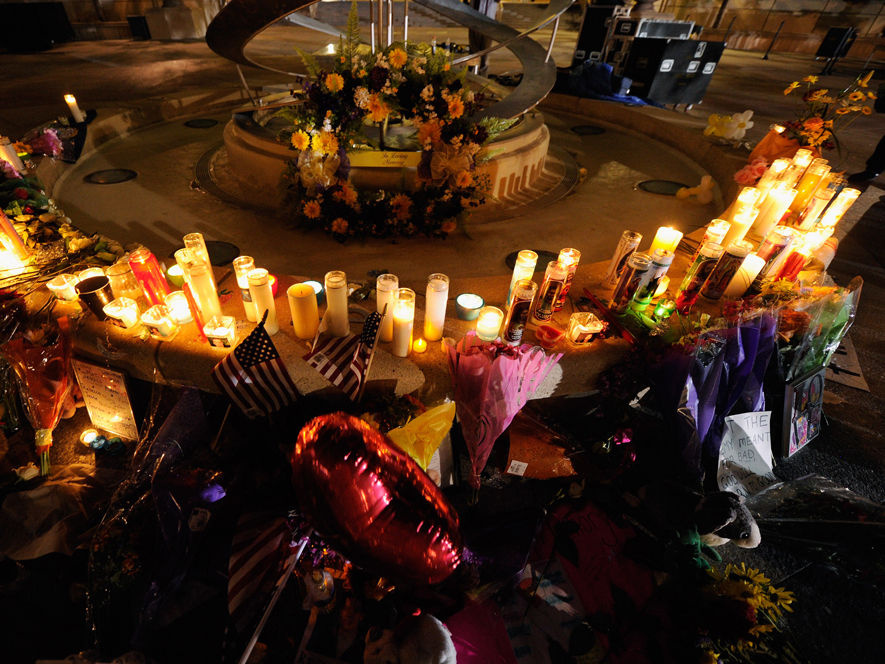 Mourners create a memorial at the fountain of the Aurora Municipal Center after a prayer vigil Sunday for the 12 victims of Friday's mass shooting at the Century 16 movie theater. National politicians are shying away from serious gun control debates after the tragedy, afraid to take on the powerful gun lobby.