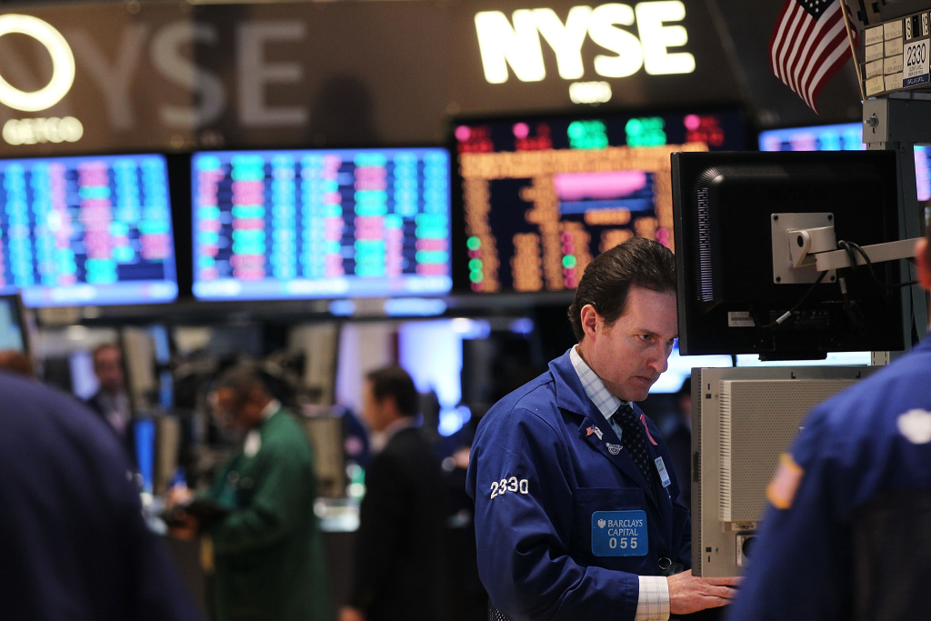 NYSE trading floor Traders work on the floor of the New York Stock Exchange on January 13, 2012 in New York City. The New York Stock Exchange is being sold to a rival exchange for about $8 billion, ending more than two centuries of independence for the iconic Big Board.
(Photo by Spencer Platt/Getty Images)