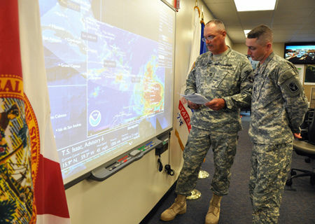 Master Sgt. James Kersey (left) and Sgt. 1st Class Chris Brunner of the 53rd Infantry Brigade Combat Team monitor the track of Tropical Storm Isaac from the Florida National Guard's Joint Emergency Operations Center in St. Augustine, Fla., Aug. 22, 2012.