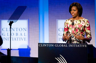 First Lady Michelle Obama speaks while former President Bill Clinton looks on during the closing plenary session of the annual Clinton Global Initiative (CGI) on September 23, 2010 in New York City.