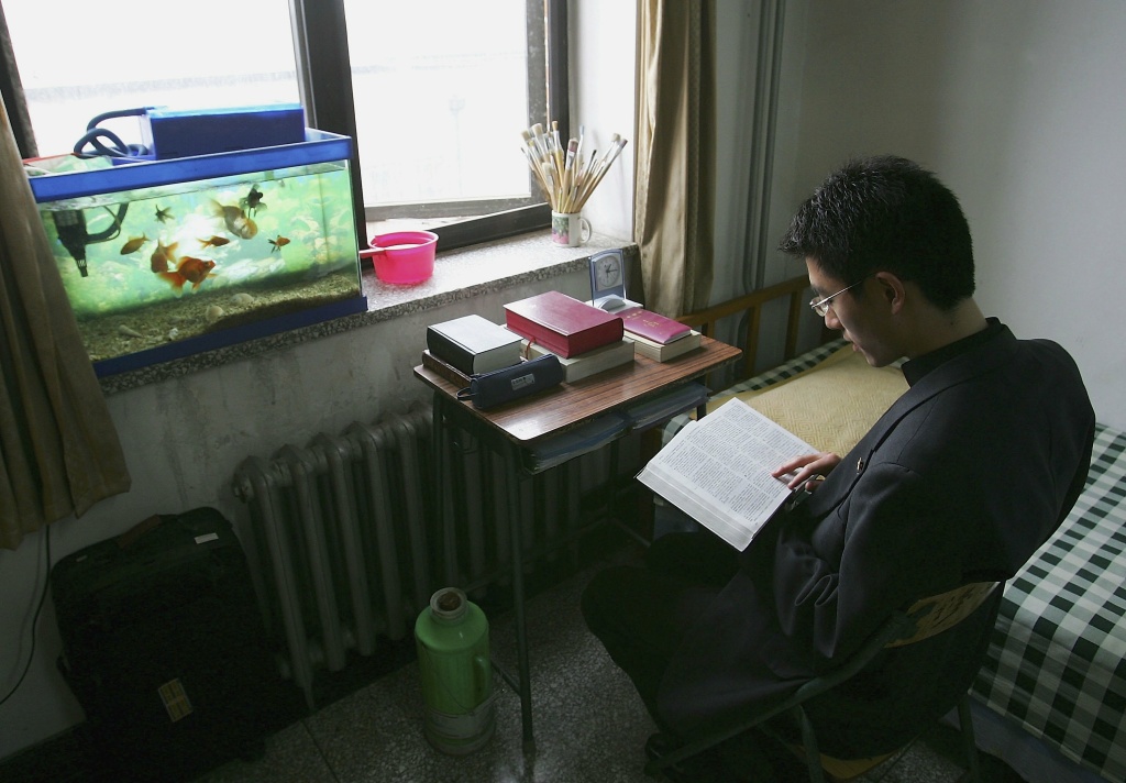 Adherents Study At The Beijing Catholic Seminary Andreas Ding, 25, from Chongqing city, studies the Bible in his dormitory in the Catholic Seminary of Beijing on May 9, 2006 in Beijing, China.
