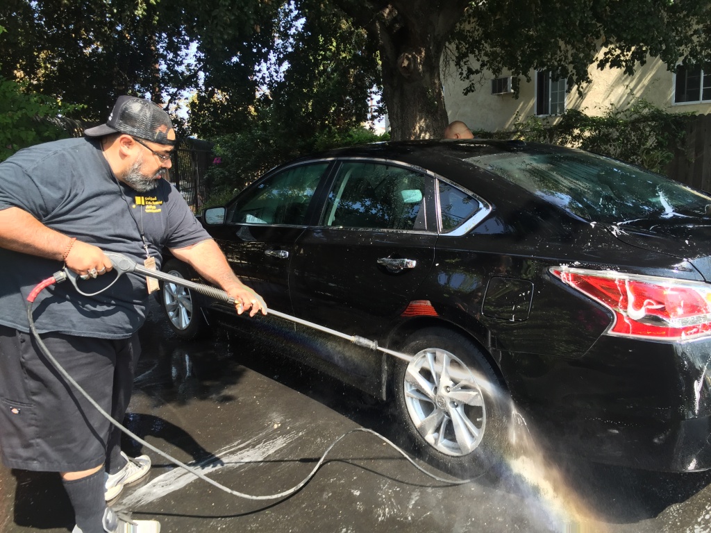 Johnny Torres, community intervention worker with Soledad Enrichment Action, raises money at a carwash in Lincoln Heights for the family of Jesse Romero Aug. 20. Johnny Torres, community intervention worker with Soledad Enrichment Action, raises money at a carwash in Lincoln Heights for the family of Jesse Romero Aug. 20.