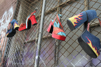 High-heel shoes hang from a gated window in an empty alley behind the National Lodge Motel. The Oakland city attorney has filed suit against the motel, arguing that it knowingly facilitates child sex trafficking.