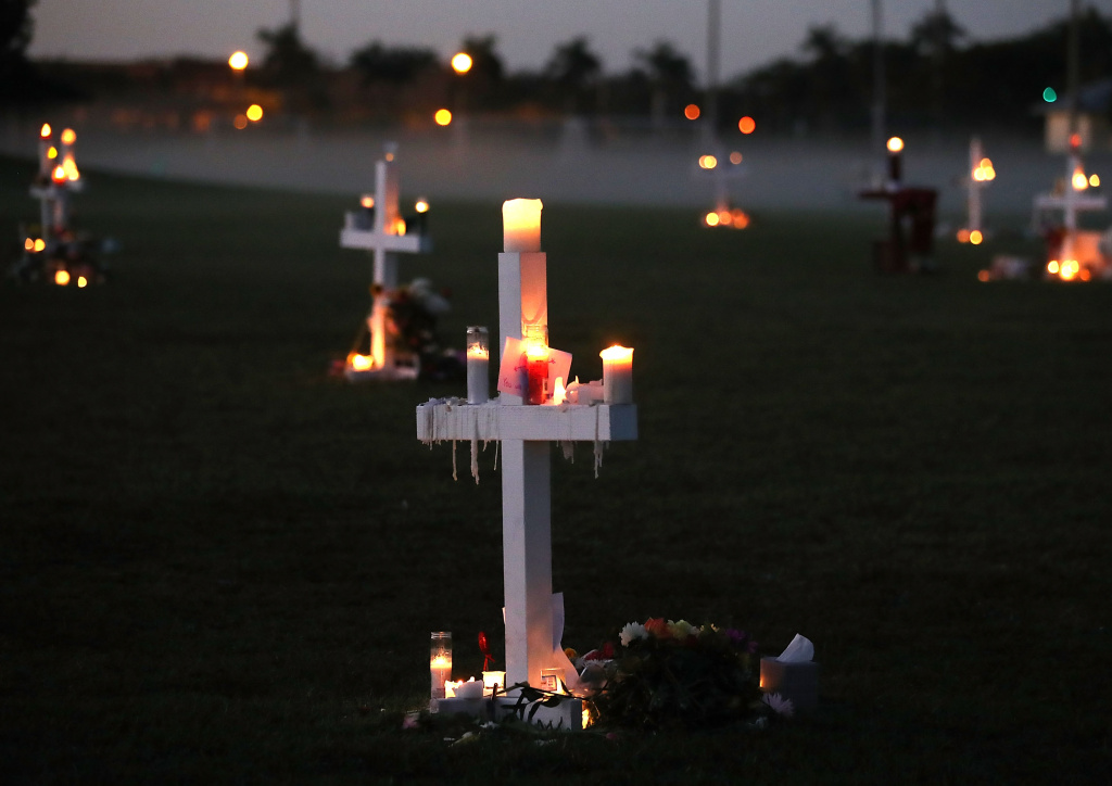 Florida Town Of Parkland In Mourning, After Shooting At Marjory Stoneman Douglas High School Kills 17 Candles glow at a memorial site to honor 17 people who were killed in the February 14, 2018 shooting at Marjory Stoneman Douglas High Schoo in Parkland, Florida.