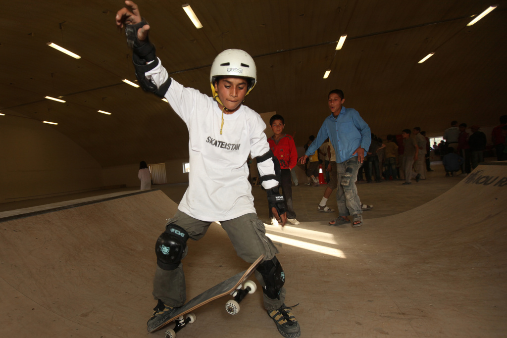 A young Afghan skateboarder enjoys a ska A young Afghan skateboarder enjoys a skatepark during a promotional event held by the 'Skateistan' NGO in Kabul on June 21, 2010. Skateistan aims to engage growing numbers of urban and internally-displaced youth in Afghanistan through skateboarding.