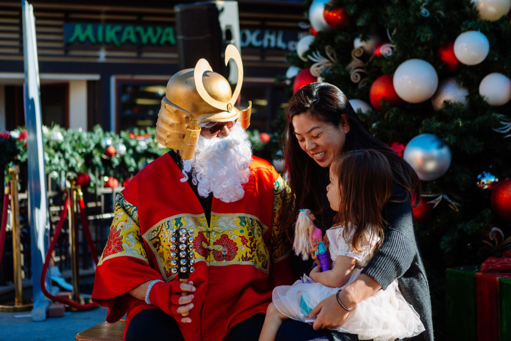 Shogun Santa Mike Okamoto poses as Shogun Santa with visitors to Japanese Village.