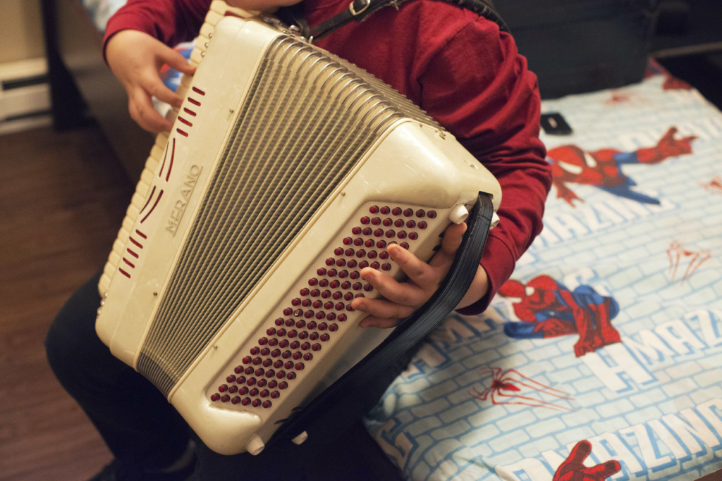_dsc6743-edit_custom-c6690175e8cc96e3b4453db8d0481592c952513d-s1300-c85.jpg Alex, 14, plays the accordion in his bedroom. He has been learning how to play one of his dad's favorite songs, La Puerta Negra, or