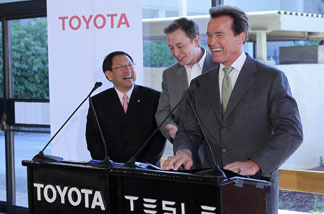 Toyota CEO Akio Toyoda, Tesla Motors CEO Elon Musk and California governor Arnold Schwarzenegger laugh during a news conference at Tesla Motors headquarters May 20, 2010 in Palo Alto, California.