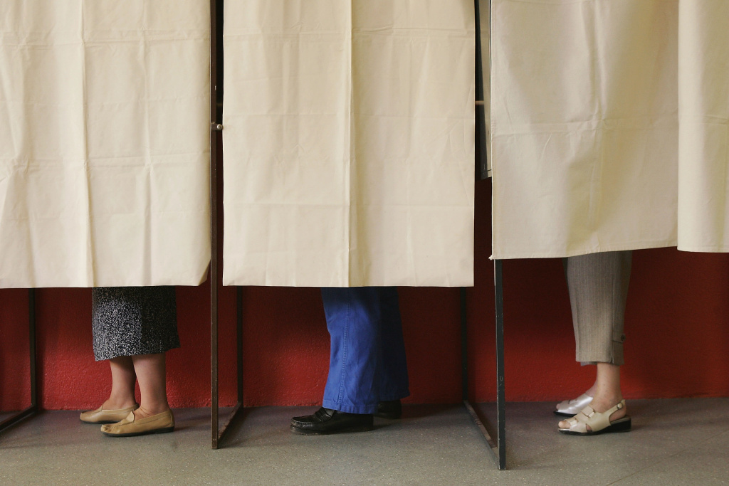 vote voter voting election French Presidential Elections - Second Round Voting People cast their ballots in the morning of the final round of French presidential elections May 6, 2007 in Melle, France. France is choosing between conservative candidate Nicolas Sarkozy and Socialist candidate Segolene Royal in a race that the last polls show Sarkozy with a significant lead.