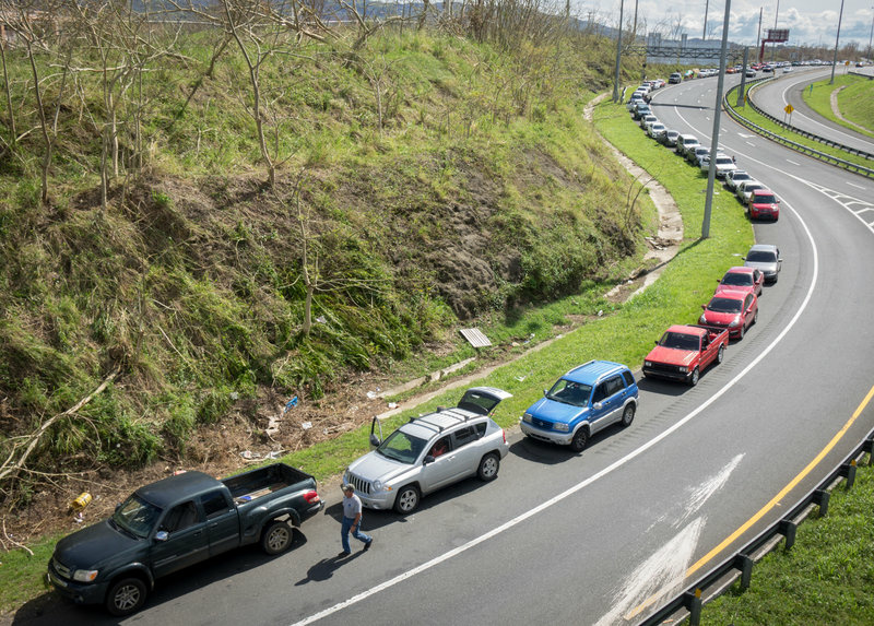 Puerto Rico Hurricane A line of cars stretches a mile as people wait in line at the Gulf Route 65 gas station for a gasoline tanker scheduled to arrive with fuel sometime Monday in Rio Grande, Puerto Rico. People have been waiting with gas canisters since before sunrise.
