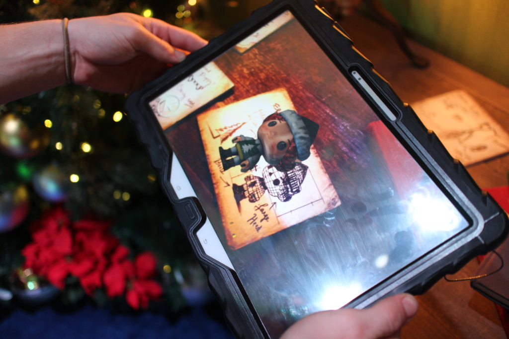 An augmented reality image of an elf is shown on a tablet screen as part of the HGTV Santa HQ attraction at Lakewood Center mall. An augmented reality image of an elf is shown on a tablet screen as part of the HGTV Santa HQ attraction at Lakewood Center mall.