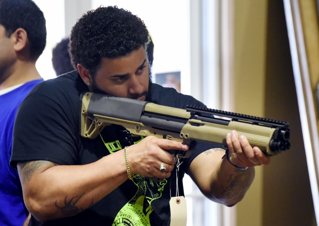 US-SOCIETY-CULTURE-GUNS A gun enthusiast checks a weapon at the South Florida Gun Show at Dade County Youth Fairgrounds in Miami, Florida, on February 17, 2018.
