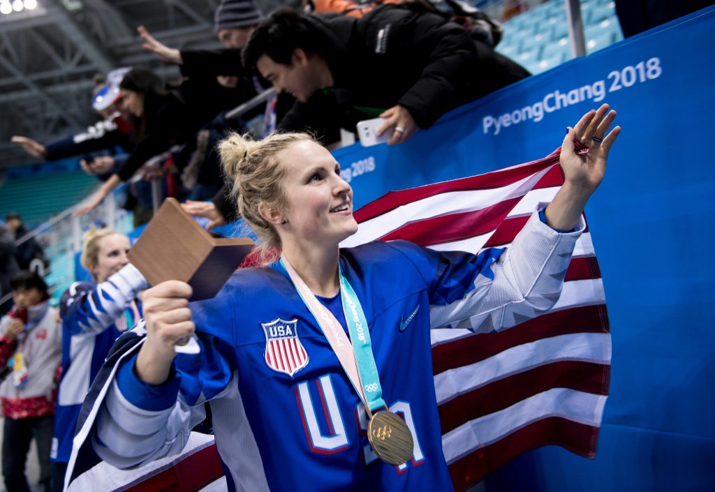 IHOCKEY-OLY-2018-PYEONGCHANG-US-CAN Jocelyne Lamoureux-Davidson walks with her gold medal and an American flag after the U.S. women's ice hockey team's overtime victory against Canada during the Pyeongchang 2018 Winter Olympic Games on February 22, 2018.