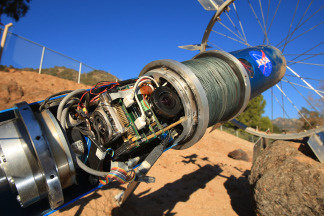 The computer system and one of its cameras are seen with the cover removed from Axel, a research prototype rover for exploring the Moon, Mars and other planets, as engineers from Jet Propulsion (JPL) and grad students from Caltech (California Institute of Technology) demonstrate its mobility over the steep and rocky grounds of the JPL Mars Yard on January 14, 2009 in Pasadena, California.