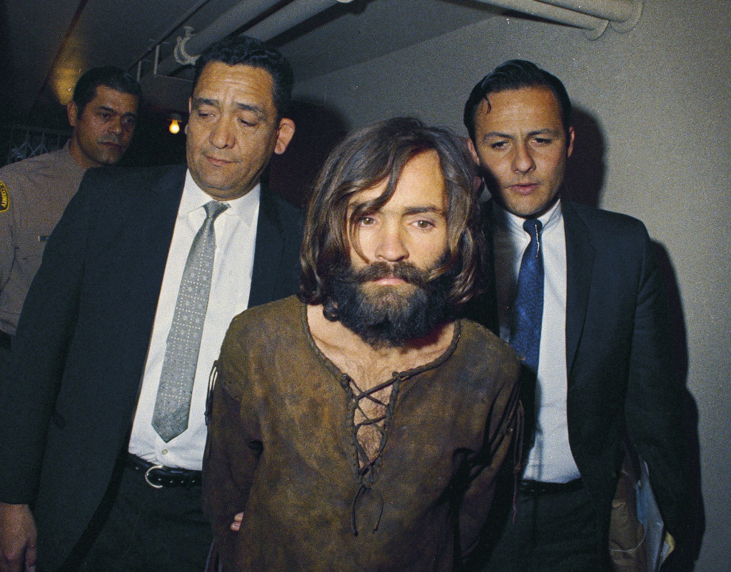 Obit Charles Manson In this 1969 file photo, Charles Manson is escorted to his arraignment on conspiracy-murder charges in connection with the Sharon Tate murder case.