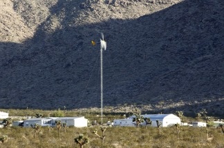 A wind-driven turbine drives an electrical generator on private property near a site proposed for wind turbines in the Mojave Desert near the town of Apple Valley, Calif., on Nov. 8, 2010.