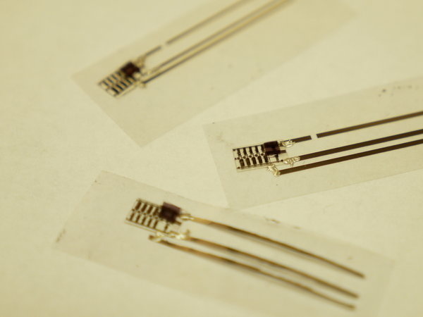 A pressure sensor is sandwiched inside layers of plastic. It senses the pressure unleashed on the plastic and changes its electrical properties. A pressure sensor is sandwiched inside layers of plastic. It senses the pressure unleashed on the plastic and changes its electrical properties.