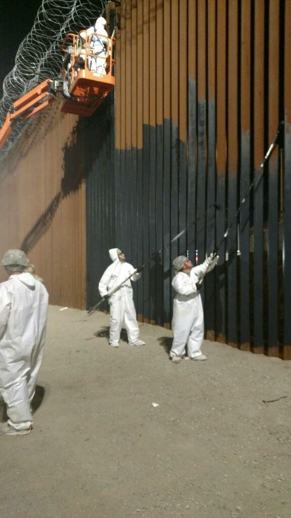 Soldiers from the 15th Engineering Company apply paint to the border wall near the Calexico West port of entry in California. Soldiers from the 15th Engineering Company apply paint to the border wall near the Calexico West port of entry in California.