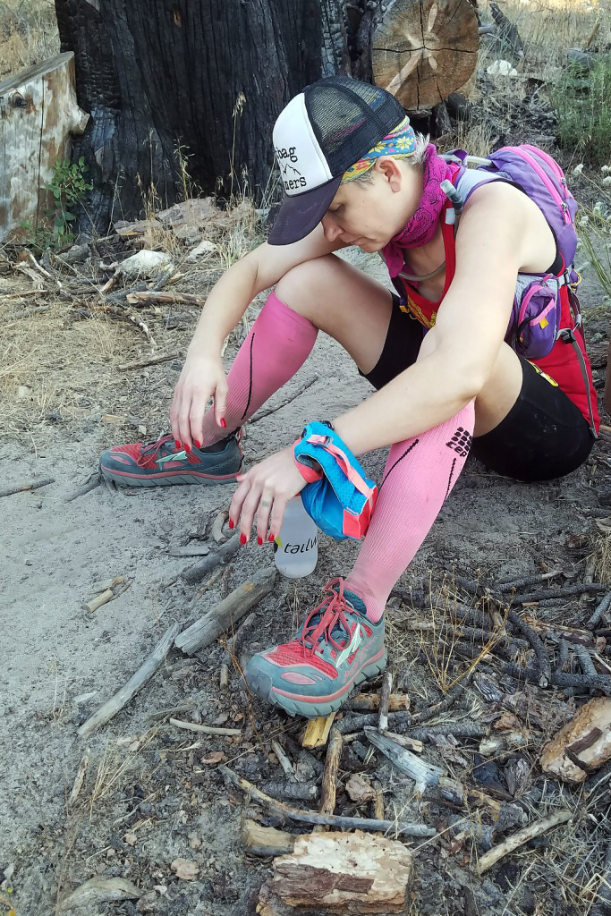 Martine Sesma - Inline 2 Runner Martine Sesma sits alongside the trail course at about mile 51 of the Angeles Crest 100 trying to gather the strength to continue the run.