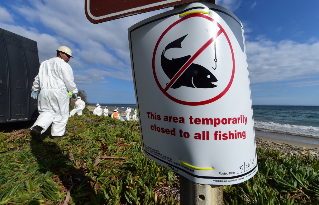 US-OIL-POLLUTION A sign is posted closing the beach to all fishing as an environmental cleanup crew helps with the clearing of oil-tainted items found at Refugio State Beach in Santa Barbara County, in California on May 21, 2015. The governor of California declared an emergency as crews scrambled to contain an oil slick and clean up popular beaches after a pipeline rupture dumped thousands of gallons of oil into the ocean. AFP PHOTO / FREDERIC J. BROWN (Photo credit should read FREDERIC J. BROWN/AFP/Getty Images)