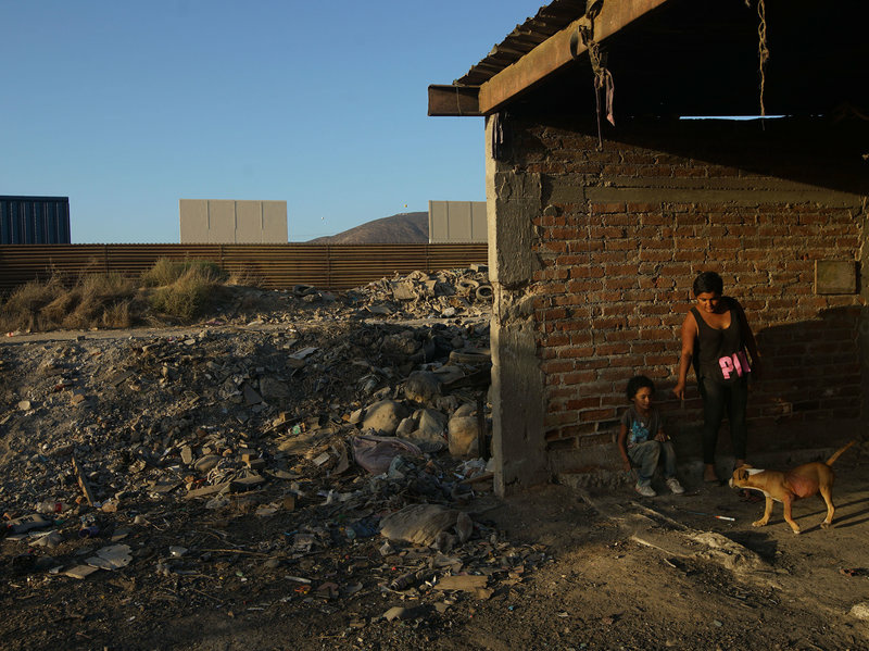 Border Wall Aurelia Rodriguez and her daughter Melanie stand in a structure in Tijuana, Mexico, with a view of border wall prototypes under construction.