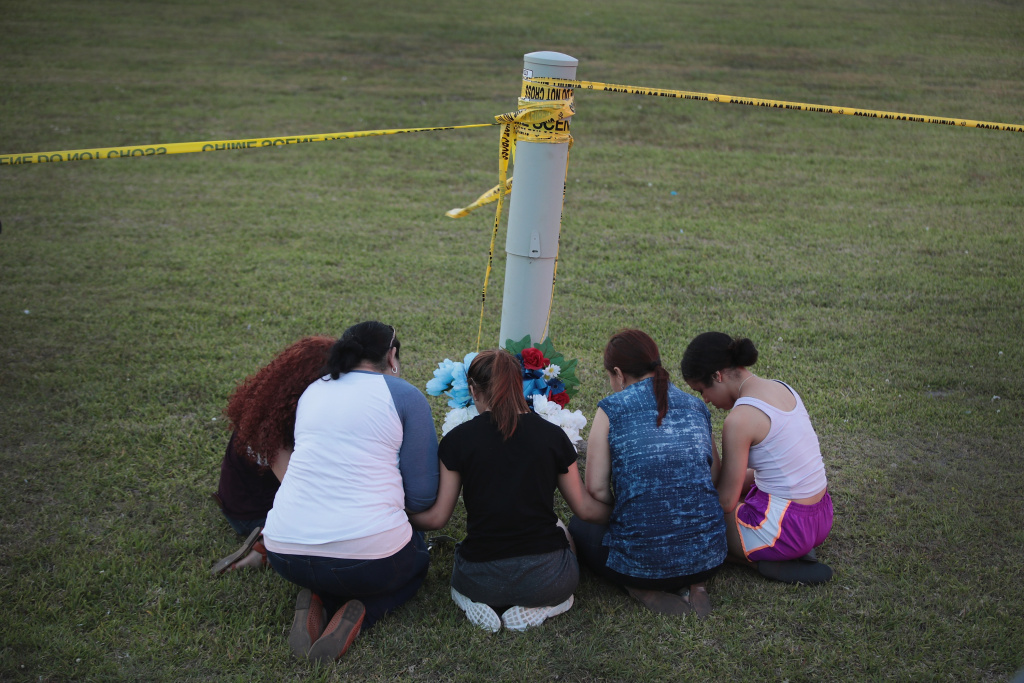 Deadly Shooting At Santa Fe High School In Texas Leaves 10 Dead Mourners say a prayer after leaving flowers in front of Santa Fe High School on May 19, 2018 in Santa Fe, Texas. The day before, 17-year-old student Dimitrios Pagourtzis entered the school with a shotgun and a pistol and opened fire, killing 10 people.