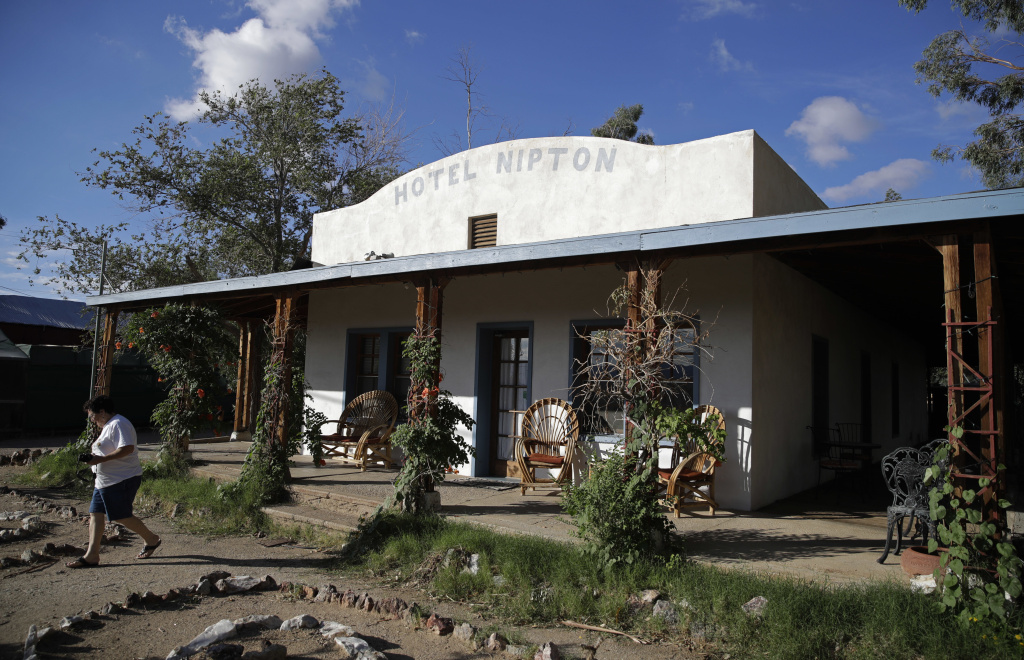 Marijuana Town A woman walks out of the Hotel Nipton, Thursday, Aug. 3, 2017, in Nipton, Calif. American Green Inc., one of the nation's largest cannabis companies, announced it has bought the entire 80 acre California desert town of Nipton.