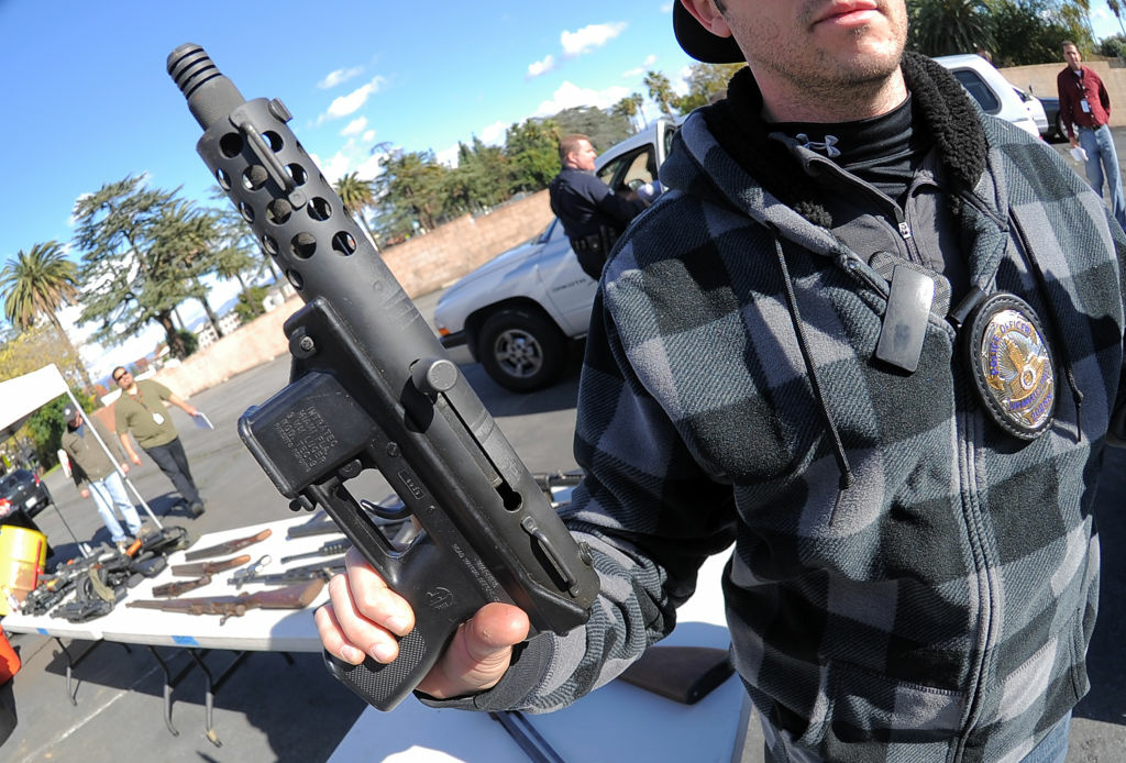 US-SHOOTING-GUNS-BUYBACK An LAPD officer hold a collected assault weapon during the Gun Buyback Program event in the Van Nuys area of north Los Angeles on December 26, 2012. By noon the LAPD had collected more then 420 handguns, rifles, shotguns and assault rifles. Los Angeles' no-questions-asked gun buyback event, where weapons could be exchanged for up to $200, was held five months early after the Connecticut school shooting. Critics question the effectiveness of gun buyback events, arguing that the weapons surrendered tend to be the least likely to be used in criminal activities, such as guns which are old or malfunctioning.