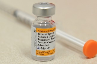 A bottle of the pertussis vaccine against whooping cough and a syringe are shown in a pharmacy in Pasadena.